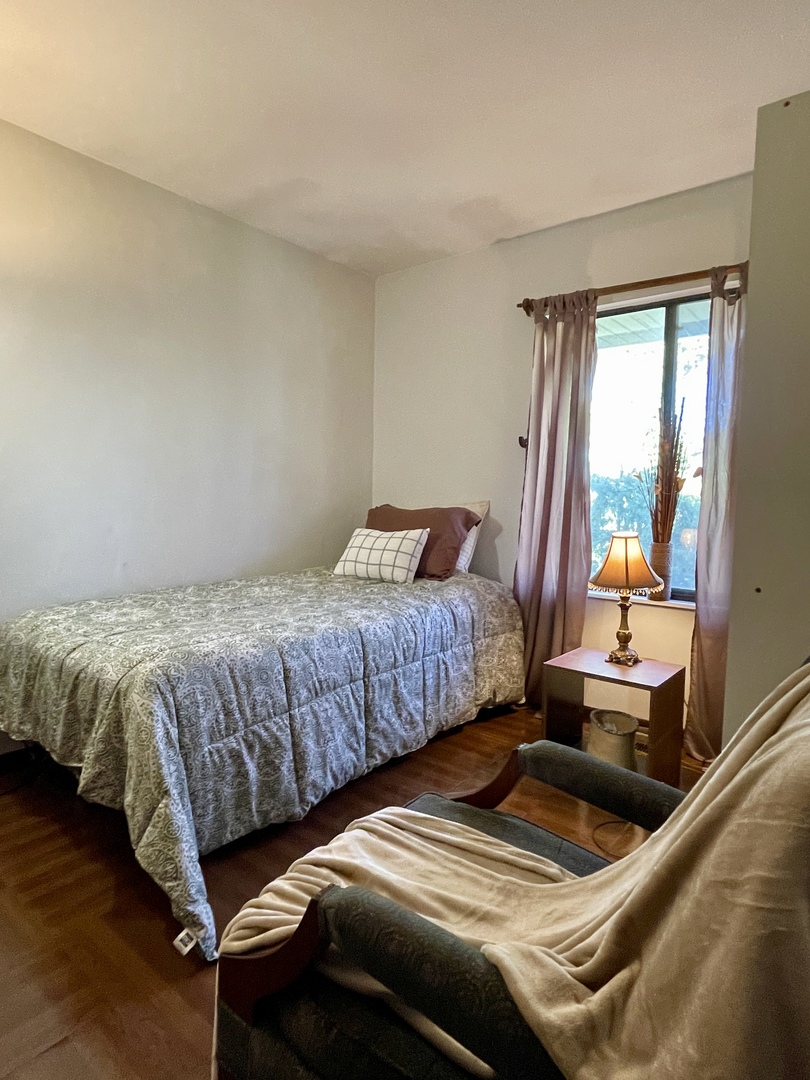 3406 Seine Court Hazel Crest, IL 60429 - Photo 19 of 26 a bedroom with a bed and wooden floor