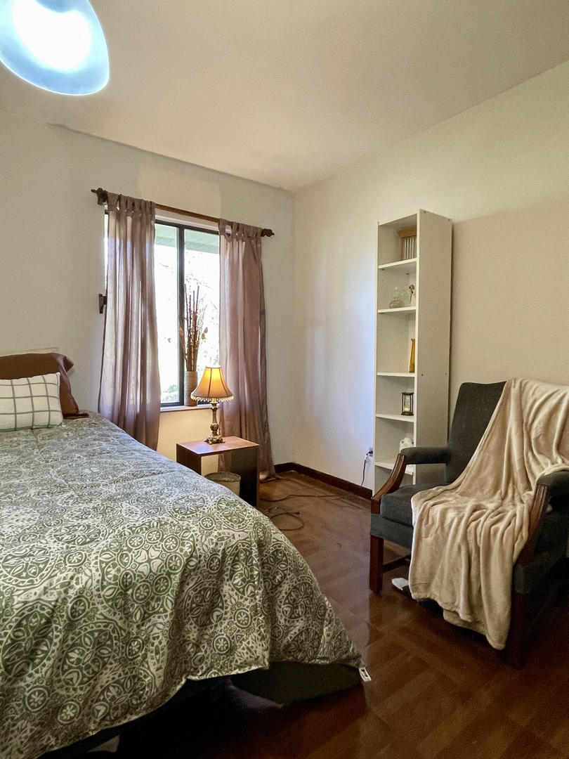 3406 Seine Court Hazel Crest, IL 60429 - Photo 20 of 26 a bedroom with a bed and wooden floor