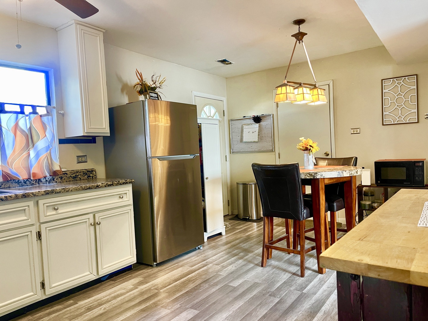 3406 Seine Court Hazel Crest, IL 60429 - Photo 2 of 26 a kitchen with stainless steel appliances a dining table chairs and wooden floor