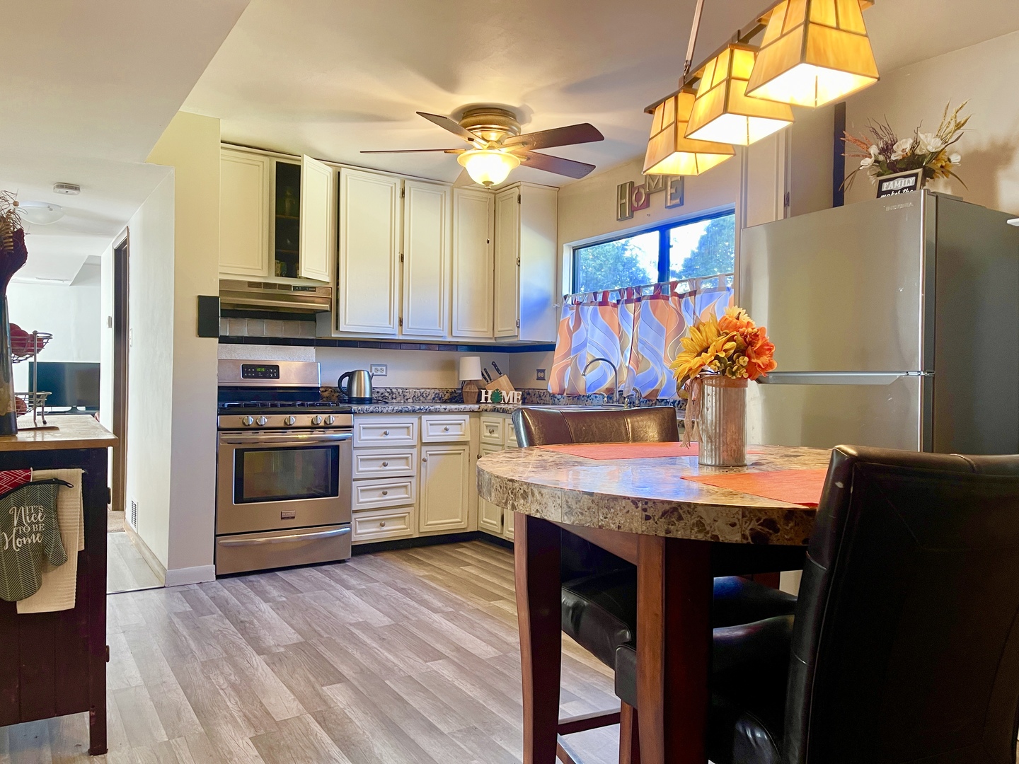 3406 Seine Court Hazel Crest, IL 60429 - Photo 5 of 26 a kitchen with stainless steel appliances kitchen island granite countertop a stove a sink and a refrigerator