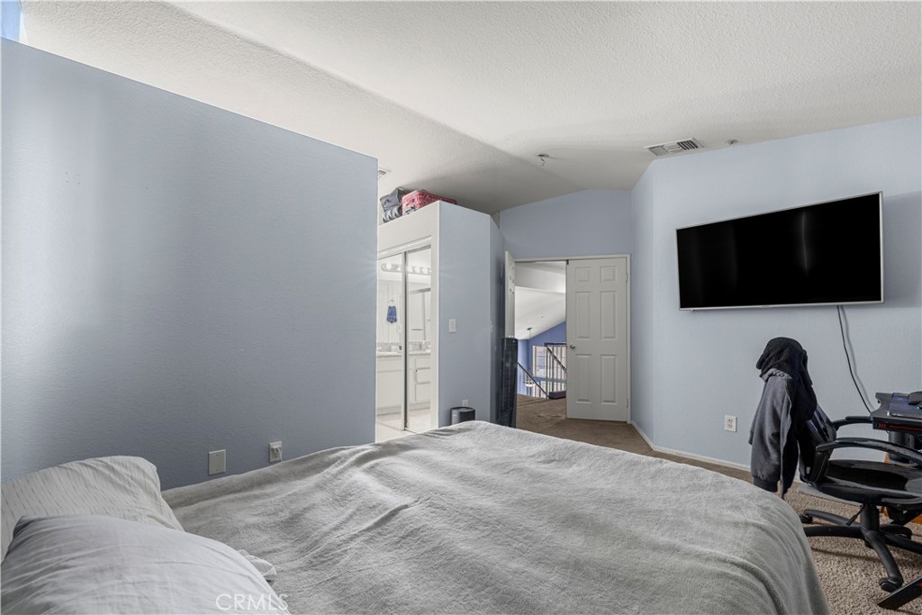 15417 Tobarra Road Fontana, CA 92337 - Photo 23 of 29 a bedroom with a bed and a flat screen tv