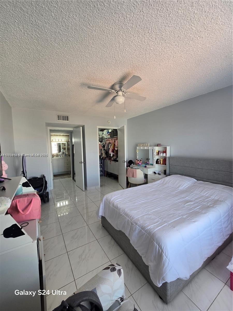 5201 Northwest 7th Street, Unit 609W Miami, FL 33126 - Photo 11 of 11 a bedroom with a bed and window