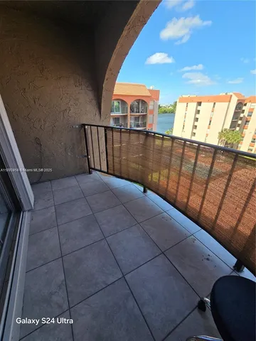 a view of balcony with wooden floor