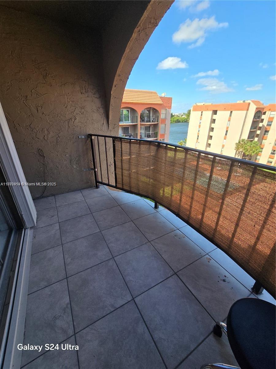 5201 Northwest 7th Street, Unit 609W Miami, FL 33126 - Photo 9 of 11 a view of balcony with wooden floor