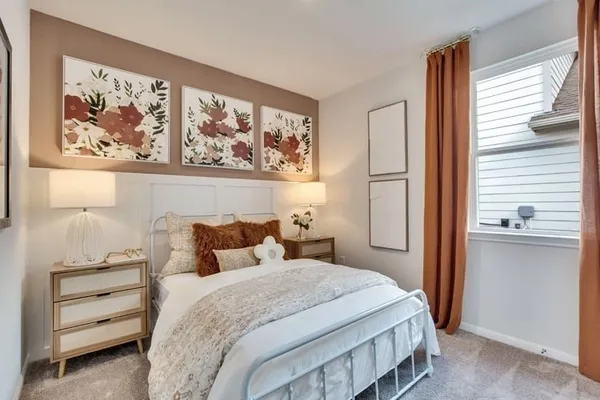 a bedroom with a bed and a painting on the wall