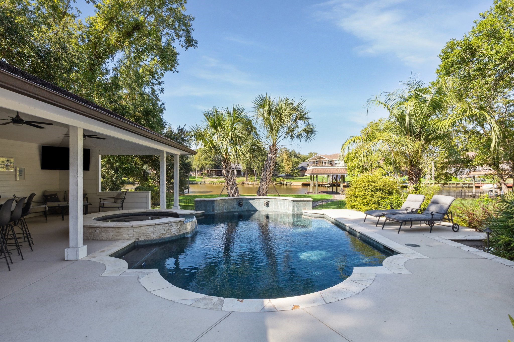 THE LUSH, REFRESHING POOL W/ COOL DECK IS SURROUNDED BY CUSTOM LANDSCAPING.