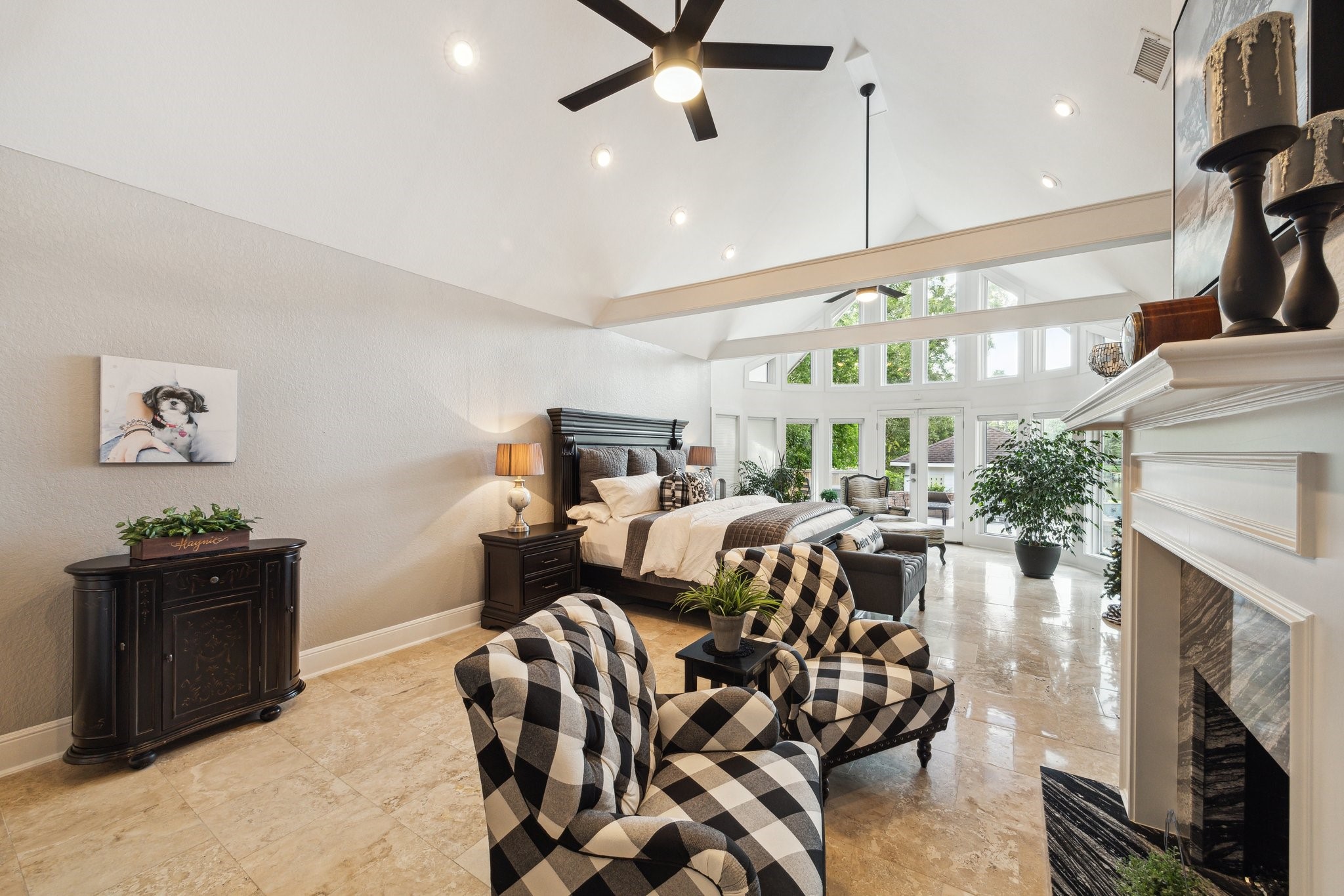 1917 Anchor Way Dickinson, TX 77539 - Photo 25 of 48 GRANDIOSE PRIMARY SUITE OFFERS A COZY FIREPLACE, GORGEOUS BEAMS COMPLIMENTING THE VAULTED CEILING, AND THAT GREAT WALL OF WINDOWS WITH AN EXIT TO THE BACK PATIO.