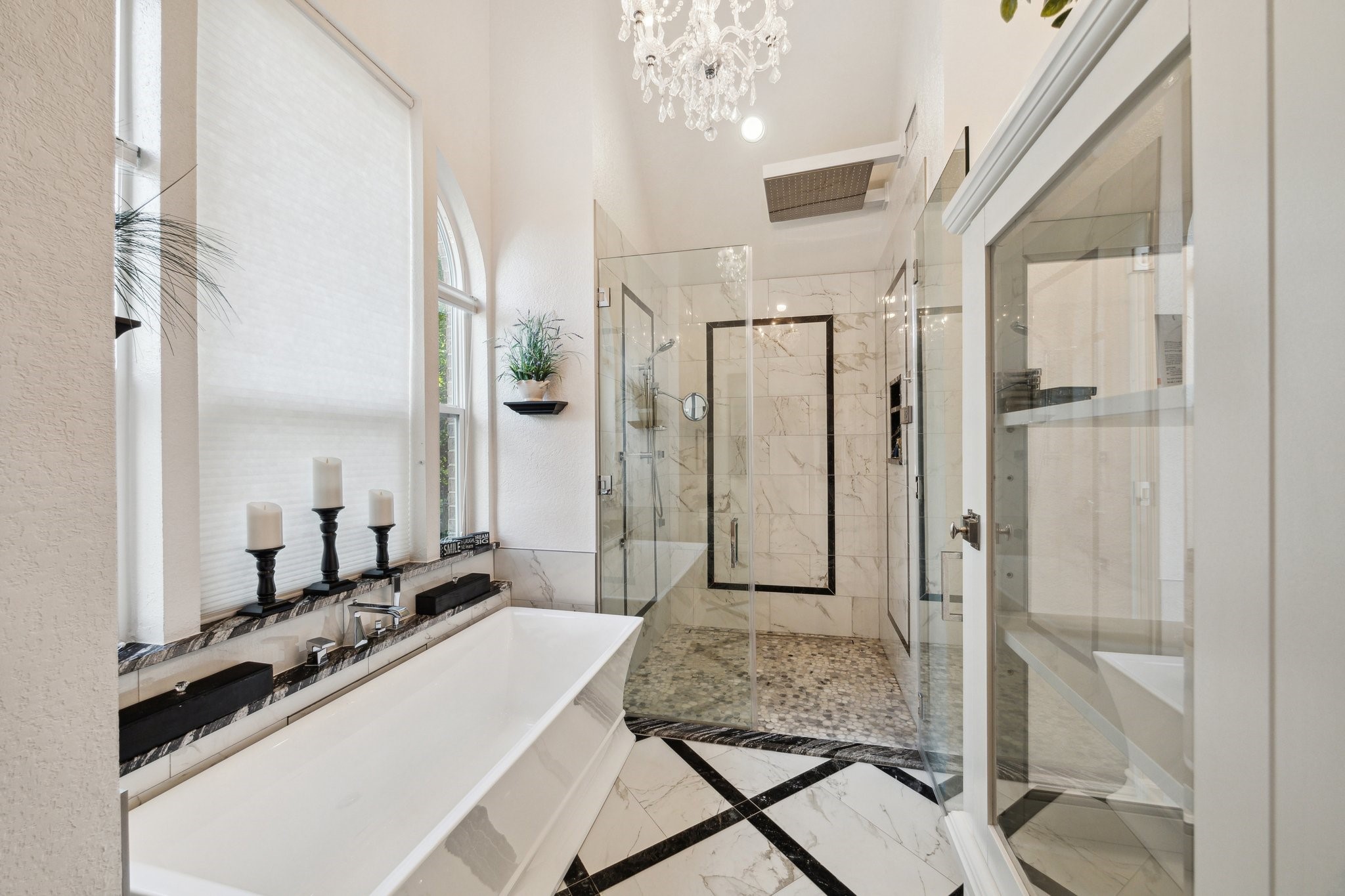 1917 Anchor Way Dickinson, TX 77539 - Photo 31 of 48 RELAX WITH A HOT SHOWER FEATURING A RAIN SHOWER HEAD AND 4 JETS AFTER A LONG WORKOUT OR DAY AT WORK IN THE HUGE WALK IN REMOTE CONTROLLED, SEAMLESS SHOWER WITH STUNNING DETAILS INLAID IN THE MARBLE WALLS
