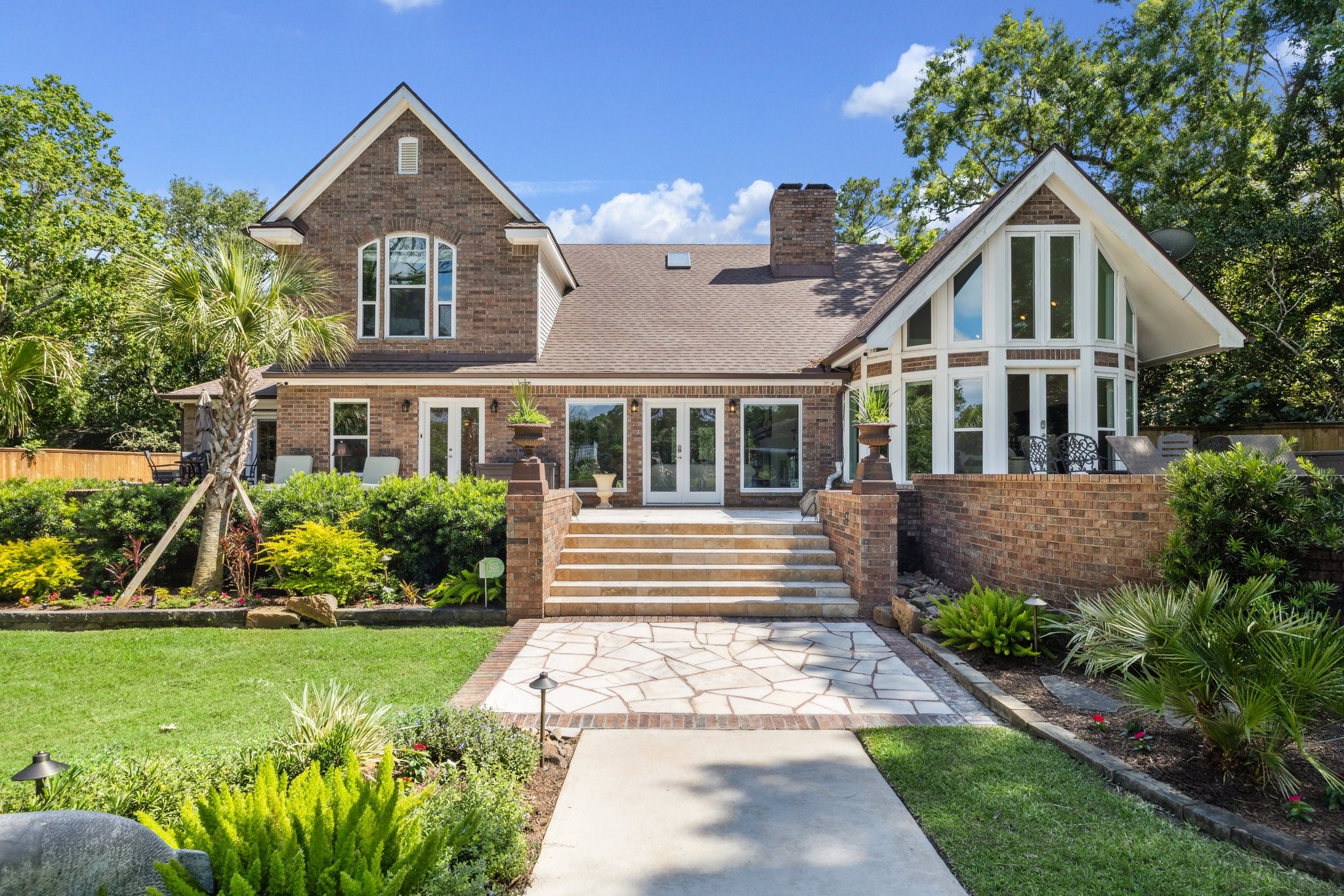 1917 Anchor Way Dickinson, TX 77539 - Photo 38 of 48 ENTER INTO YOUR CHOICE OF A ROOM THROUGH ONE OF THE 4 ENTRY DOORS FROM THE BACK OF THE HOME'S GRAND STAIRCASE. SERVE BRUNCH FROM EITHER OF THE SECLUDED PATIOS, OR ENTERTAIN MANY FRIENDS ON THE ENTIRE PORCH.