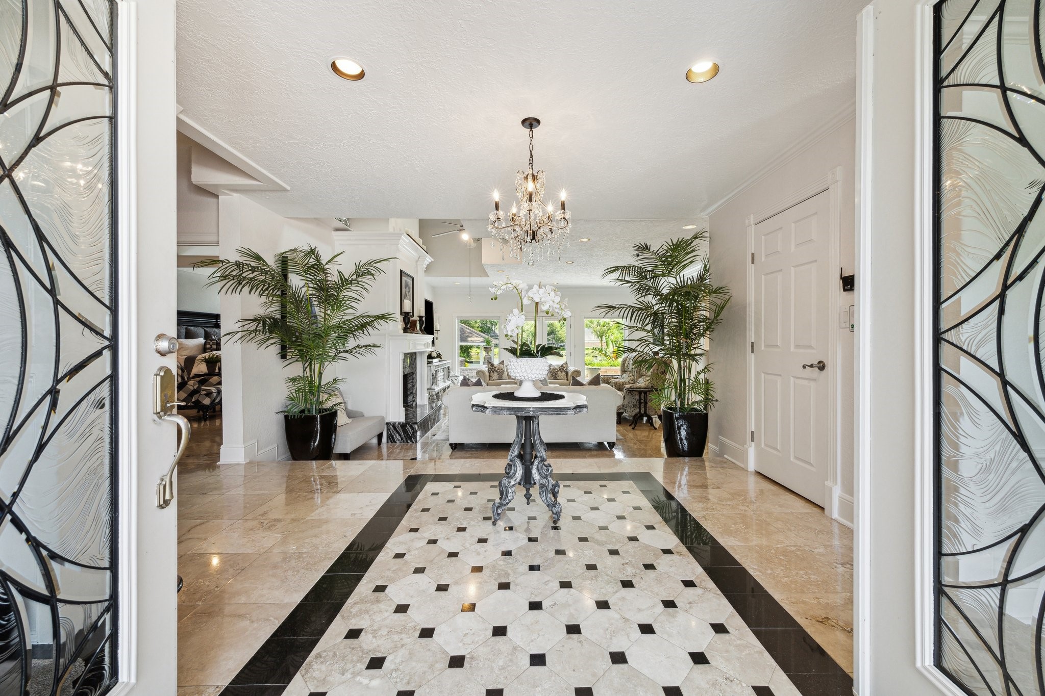 1917 Anchor Way Dickinson, TX 77539 - Photo 10 of 48 GORGEOUS LEADED GLASS FRONT DOORS TAKE YOU INTO THE PICTURESQUE HOME. CUSTOM CHANDELIER AND TRAVERTINE TILE, INSET LIGHTING