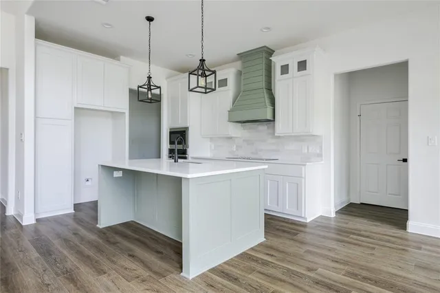 a view of a kitchen with wooden floor and a sink