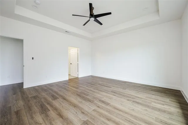 a view of empty room with wooden floor