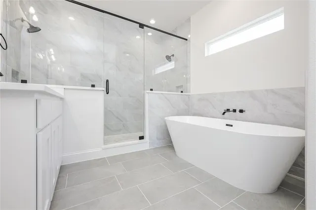 a bathroom with a bathtub and shower