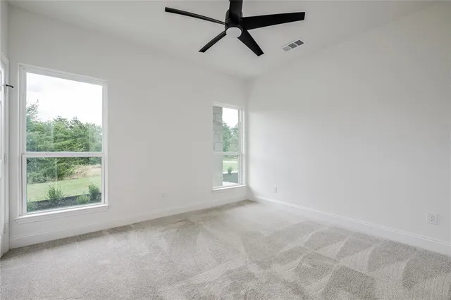 a view of a room with a window and a ceiling fan