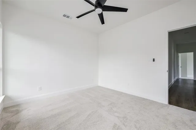 a view of an empty room with a fan