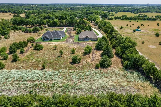 an aerial view of house with yard