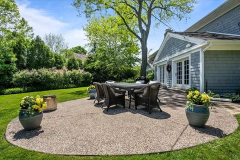 a view of a house with backyard porch and sitting area