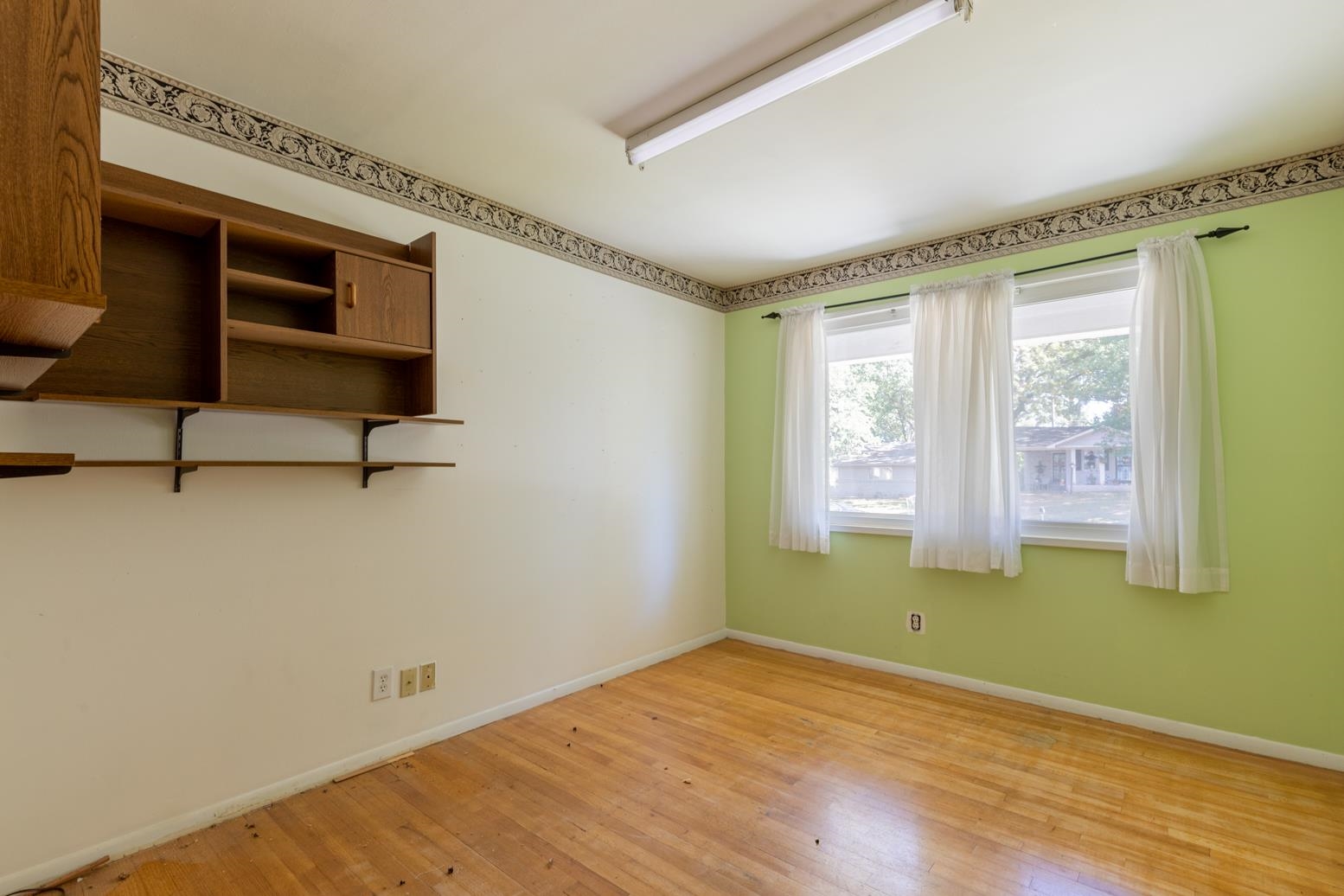 497 Fleda Road Memphis, TN 38120 - Photo 17 of 25 a view of empty room with window and wooden floor