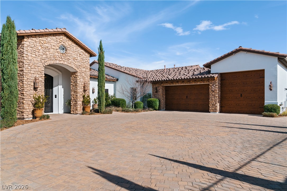 1123 Christian Road Henderson, NV 89002 - Photo 5 of 94 A spacious paver driveway welcomes you to this elegant stucco home with a stone facade and multiple garages.