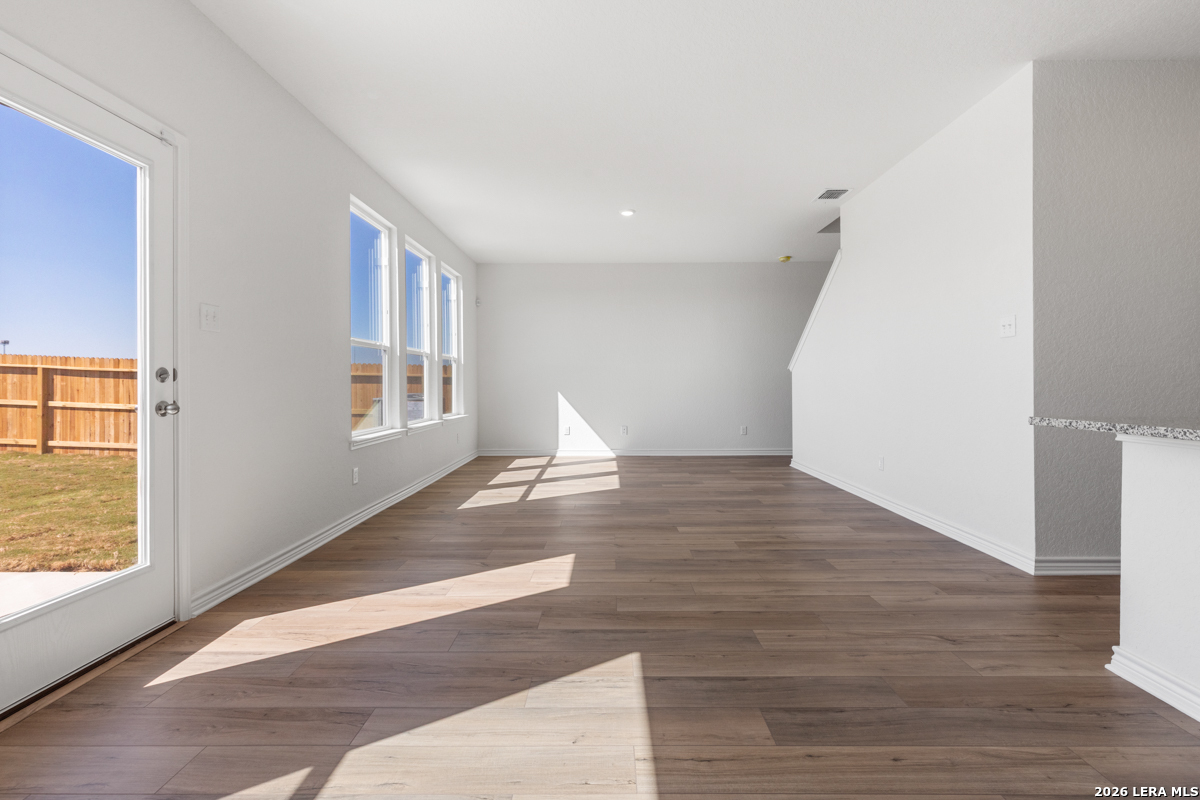 10030 Jagger Avenue Converse, TX 78109 - Photo 11 of 28 a view of empty room with wooden floor and fan