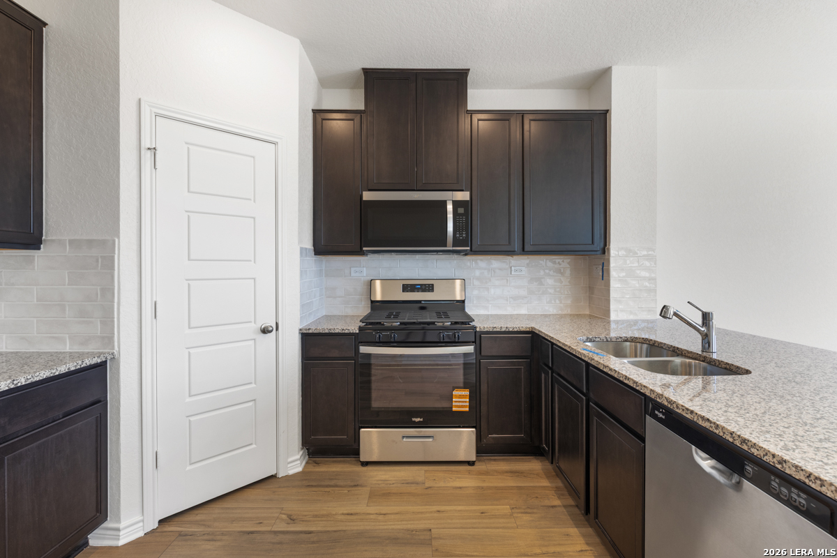 10030 Jagger Avenue Converse, TX 78109 - Photo 14 of 28 a kitchen with granite countertop a stove and a sink
