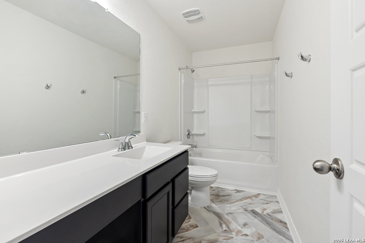 10030 Jagger Avenue Converse, TX 78109 - Photo 24 of 28 a bathroom with a sink a toilet and shower