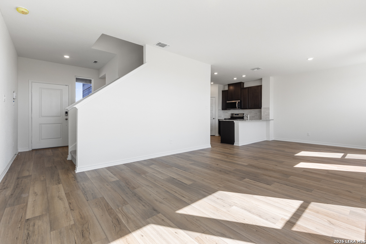 10030 Jagger Avenue Converse, TX 78109 - Photo 10 of 28 a view of a kitchen with wooden floor and a sink