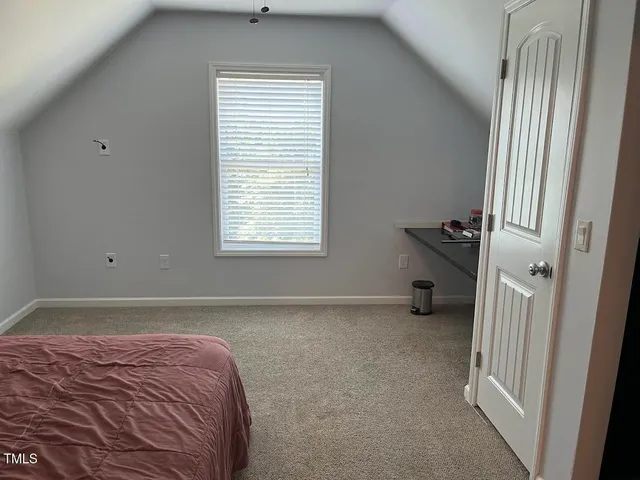 a bed room with a bed and a window