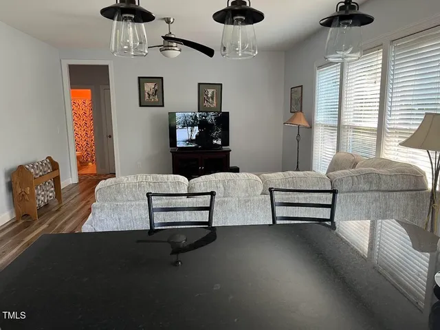 a living room with furniture and a wooden floor