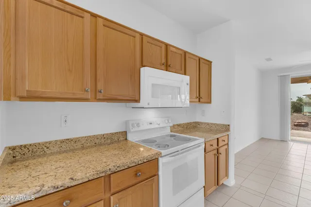 a utility room with granite countertop a sink a washer and dryer