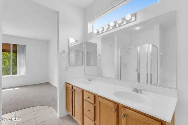 a spacious bathroom with a double vanity sink and a mirror