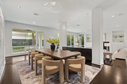 a dining room with furniture and wooden floor