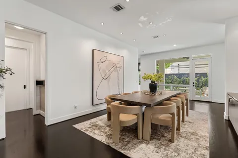 a bathroom with a granite countertop sink a mirror and wooden floor