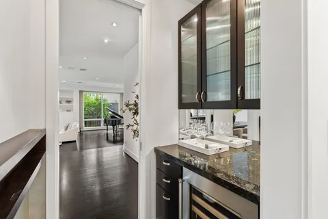 a bathroom with a granite countertop sink a mirror and wooden floor