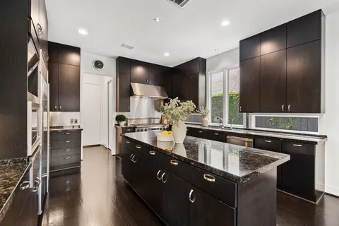 a kitchen with stainless steel appliances a sink stove and refrigerator