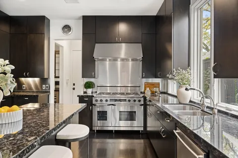 a kitchen with stainless steel appliances a stove a sink and a refrigerator