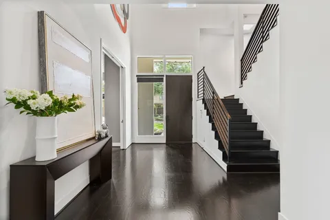 a view of entryway and hall with wooden floor