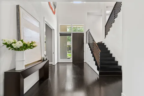 a view of entryway and hall with wooden floor