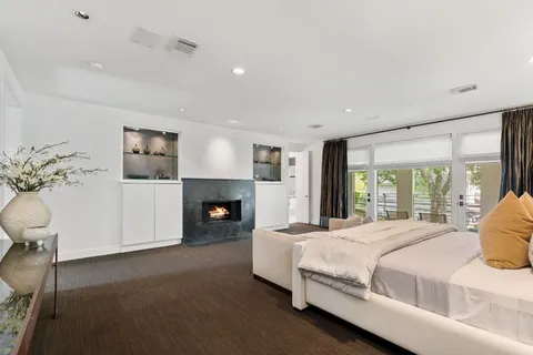 a spacious bedroom with a bed and a fireplace