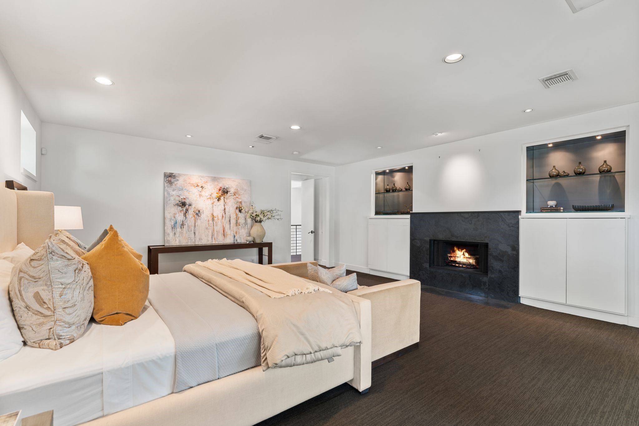 2409 Maconda Lane Houston, TX 77027 - Photo 26 of 40 a spacious bedroom with a bed and a fireplace