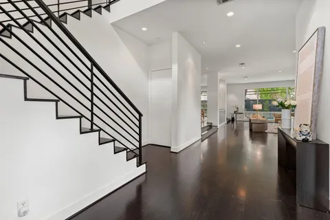 a living room with furniture and a floor to ceiling window