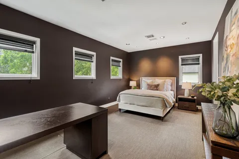 a bedroom with a bed and potted plant