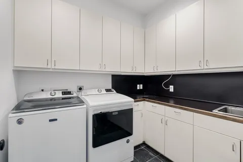a view of cabinets with stainless steel appliances granite countertop white cabinets sink and dishwasher
