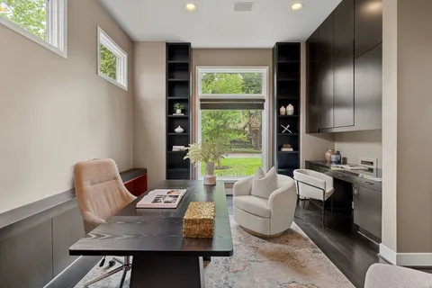 a work room with furniture and a floor to ceiling window