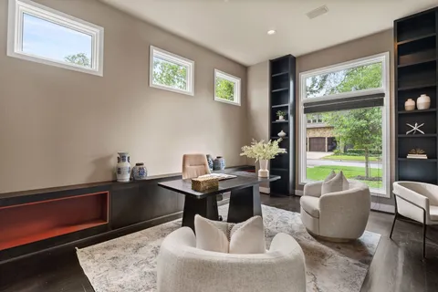 a work room with furniture and a floor to ceiling window