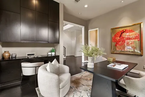 a living room with fireplace furniture and a large window