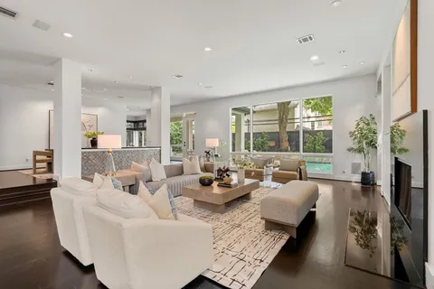 a living room with fireplace furniture and a large window