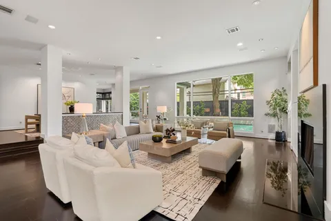 a living room with fireplace furniture and a large window