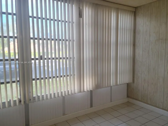 a view of a kitchen with appliances and furniture