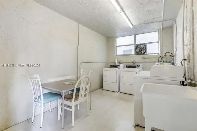 a view of living room kitchen with furniture and a chandelier